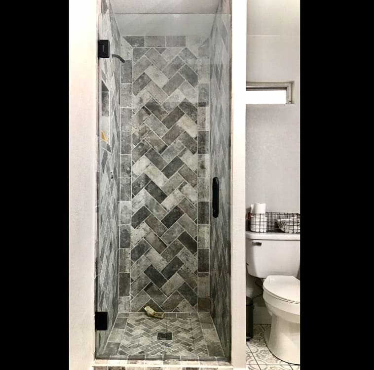 Modern frameless shower with brushed brass hardware in Green Valley Las Vegas