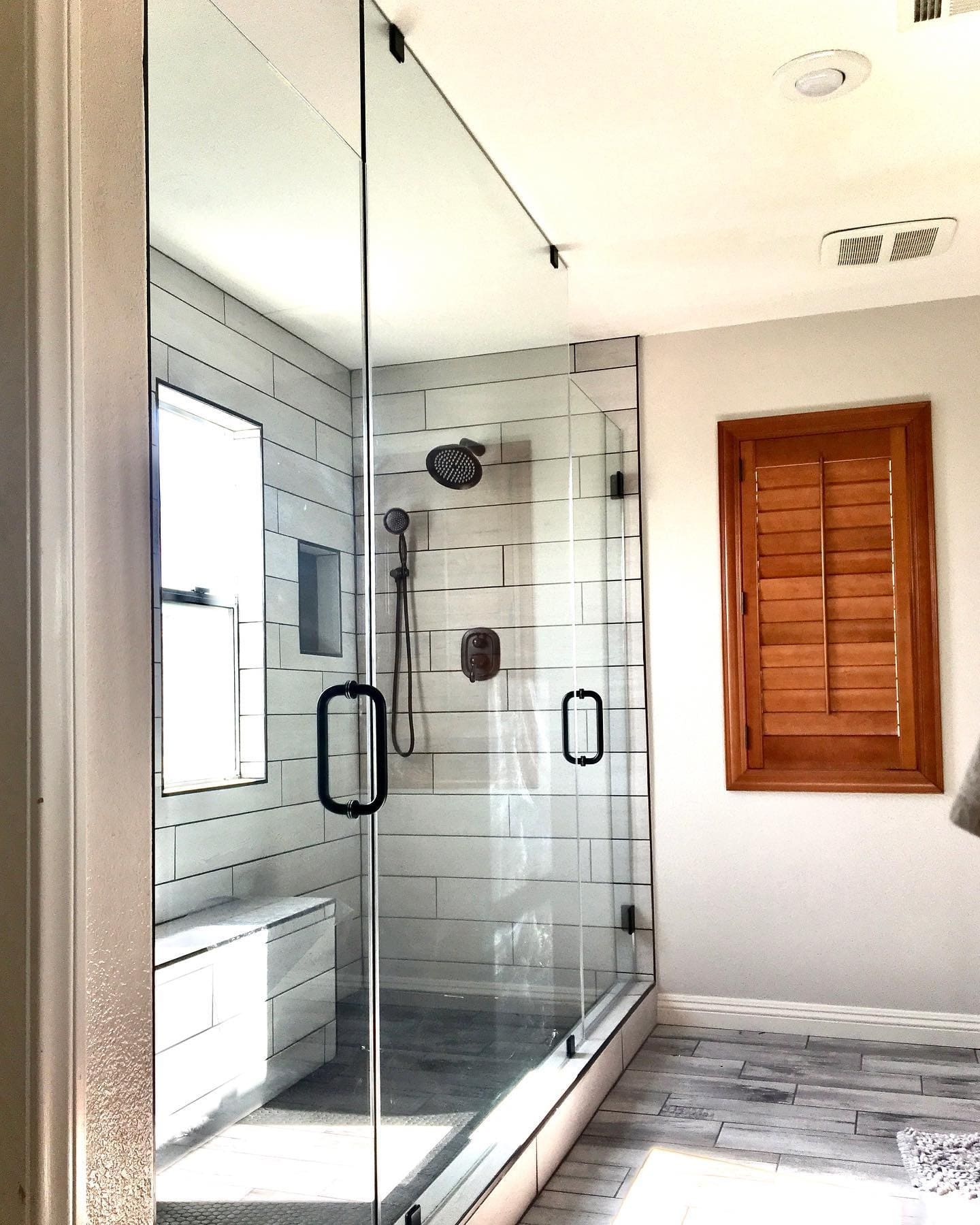 Custom frameless glass shower door with brushed nickel finish in Henderson NV